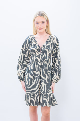 Woman wearing a patterned dress on a white background
