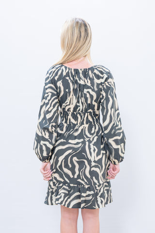 Person wearing a patterned dress on a white background