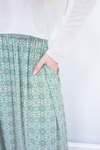 Green patterned skirt with a white background