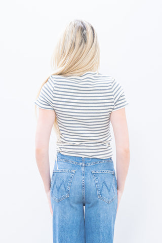 Person wearing a striped shirt and blue jeans on a white background