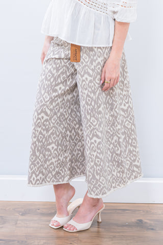 Person wearing patterned pants with a white background