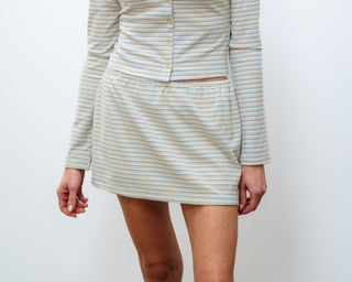 Woman wearing a striped dress against a white background