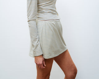 Woman wearing a striped dress against a white background